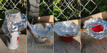 A makeshift paint pot made from aluminum foil and a spray can lid