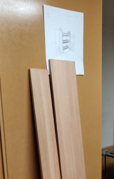 A picture of the two Douglas Fir boards with a really nice vertical grain pattern, and also showing a printout of the SketchUp model